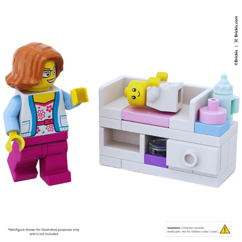  LEGO minifigure nursery set with pink baby changing table, baby bottles, storage drawers, and pastel nursery accessories.