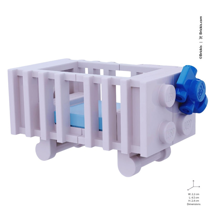 
                  
                    Brick-built LEGO white bassinet with tiny car accent detail and pastel blue blanket
                  
                