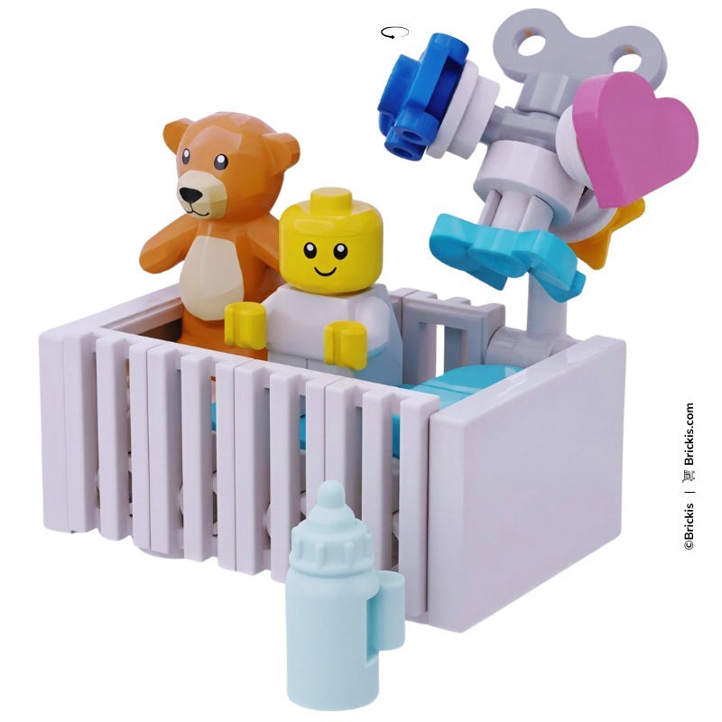 Custom LEGO baby bed in turquoise tones, includes bottle, teddy, and rotating crib mobile