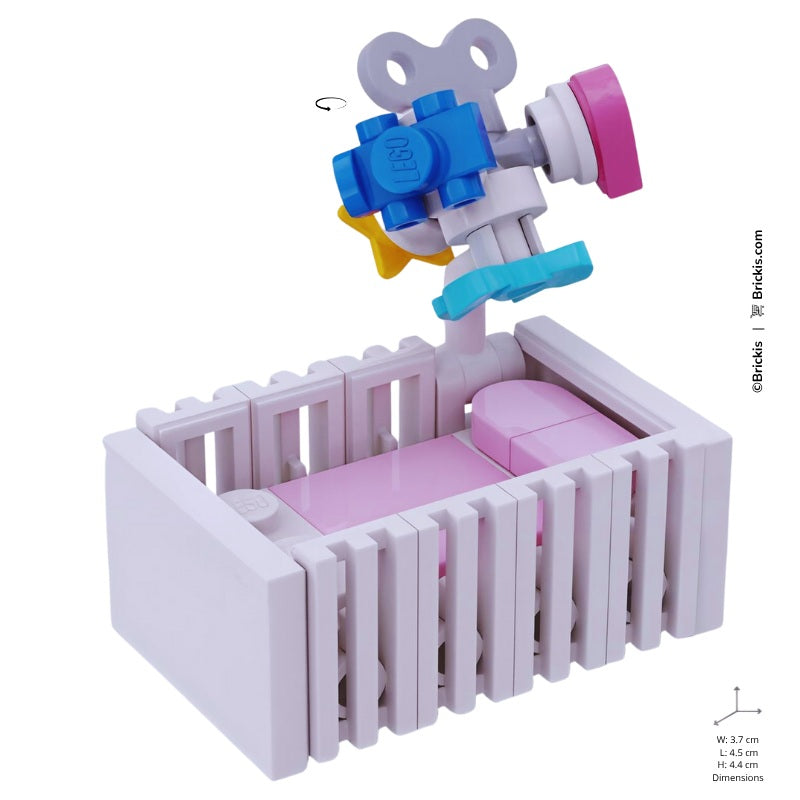 
                  
                    LEGO pastel pink baby cot with spinning mobile – designed for nursery setups
                  
                