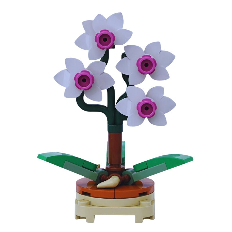 
                  
                    LEGO orchid flower shown as part of a miniature botanical set with other plants from the Botanix Collection by Brickis
                  
                